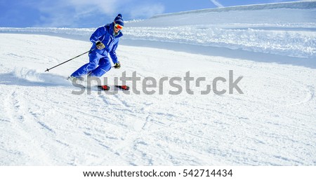 Young athlete skiing in Deux Alps french mountains on sunny day - Skier riding down for winter snow sport competition - Training and vacation concept - Warm vivid filter 