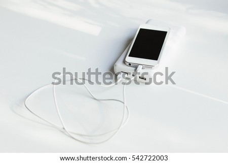 White mobile phone  with power bank (battery bank) on white background. 