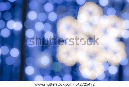 Soft, large, colorful bokeh different colors. Fill the entire background. Tender tones blue, white, yellow. Snowflake contour on the right side of the image.