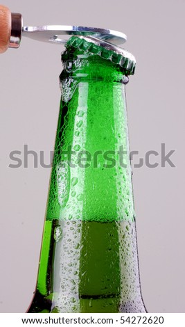 Green beer bottle being opened