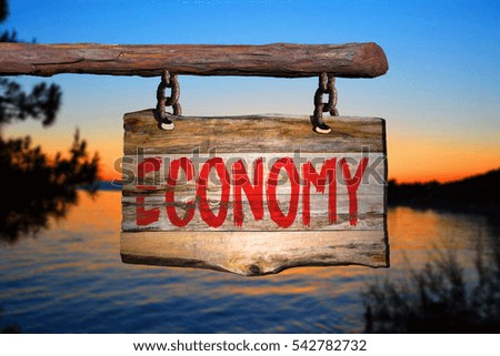 Economy motivational phrase sign on old wood with blurred background