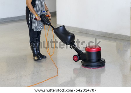 Cleaning maintenance industrial expand in big cities, cleaner staffs have to use scrubber machine for cleaning concrete floor and polishing floor for safety time.  Royalty-Free Stock Photo #542814787