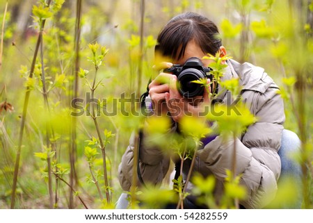 photographer ?n the nature photographing plants