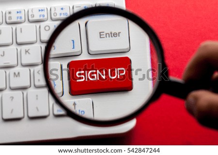SIGN UP word written on keyboard view with magnifier glass