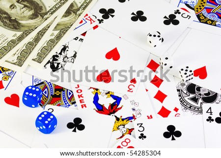 money and dice lie on the playing cards
