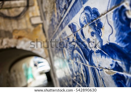 An angel figure in azulejo tiles in an alley in Lisbon, Portugal Royalty-Free Stock Photo #542890630
