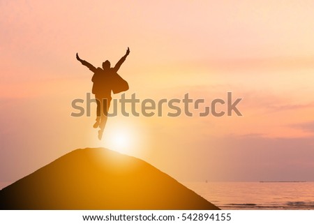 Silhouette of Business man Celebration Success Happiness on a mountain top Sunset Evening Sky Background, Sport and active life Concept. Royalty-Free Stock Photo #542894155