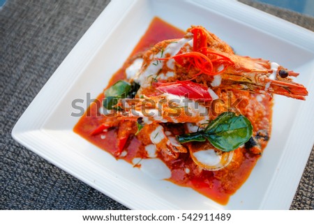 Saute shrimps with vegetables and lemon on white plate