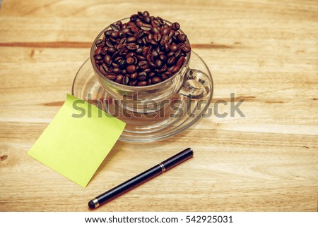 Coffee on grunge wooden background texture note