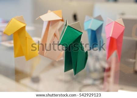 Set of colorful origami dog on the glass table