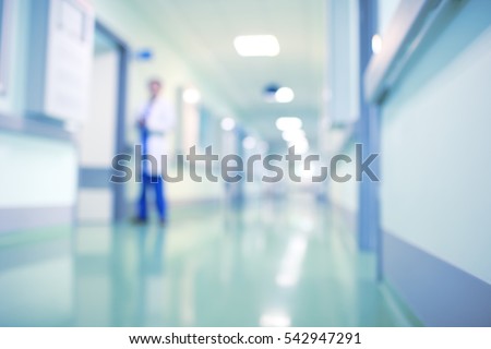 Doctor in hospital corridor, unfocused background. Royalty-Free Stock Photo #542947291