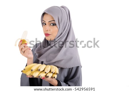 Beautiful arab muslim woman carrying fresh banana fruit on white background