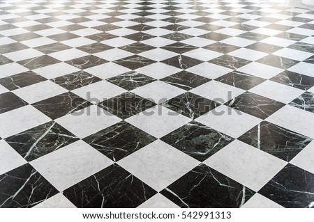 Black and white checkered marble floor with sunlight Royalty-Free Stock Photo #542991313
