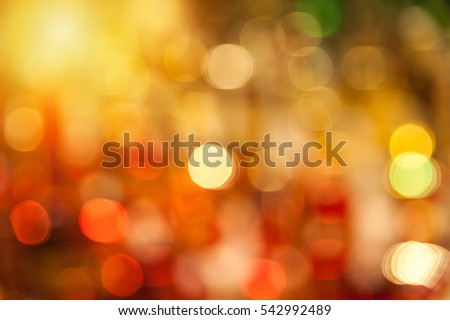Yellow and red bokeh background created by neon lights