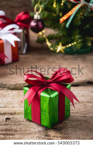 gift box with christmas trees on wooden table