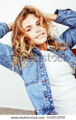 pretty young curly blond teenage girl hipster emotional posing happy smiling on white background, lifestyle people concept