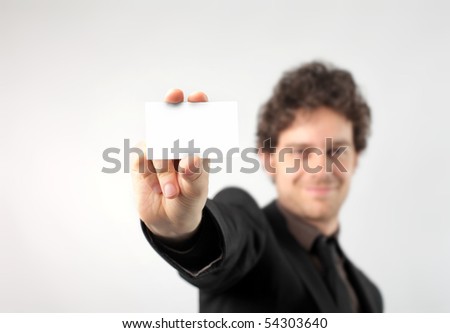 Smiling businessman showing a card