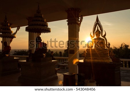 Silhouette of Buddha in a temple at evening sunset background.Thailand.