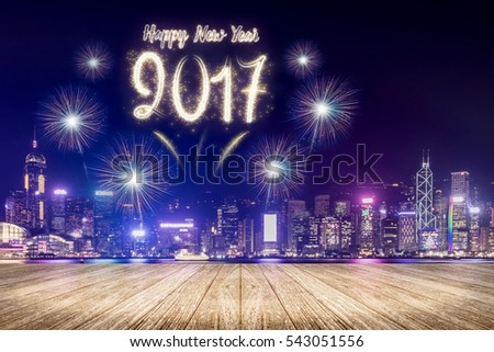 Happy new year 2017 fireworks over cityscape at night with empty wood plank floor,Mock up template for display or montage of product for social media advertising.