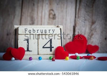 Wooden calendar show of February 14 with red heart Royalty-Free Stock Photo #543061846