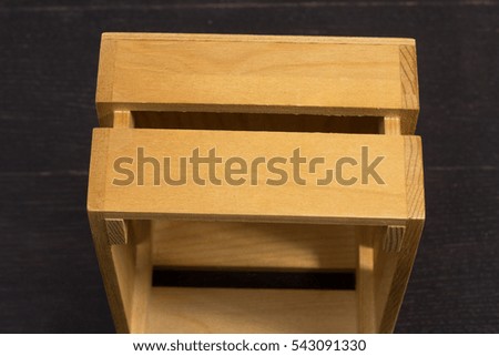 Light wooden box on a black background