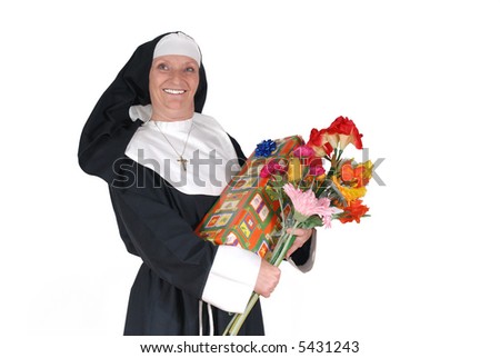 Middle aged  sister, nun with birthday present and flowers.  Religion, christianity, lifestyle,  holiday concept