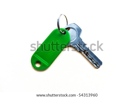 key with green trinkets isolated on a white background