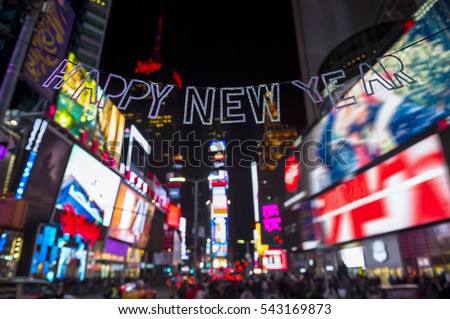 Glittery Happy New Year message strung across the flashing lights of Times Square, New York City