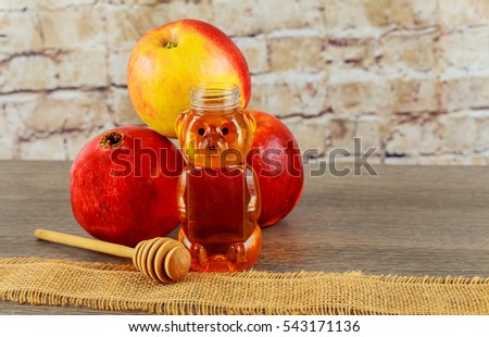 jewish symbol, Holiday symbo, Jewish holiday Jewish new year. Rosh Hashana apples, honey and pomegranates Rosh Hashana. selective focus on the middle of the honey