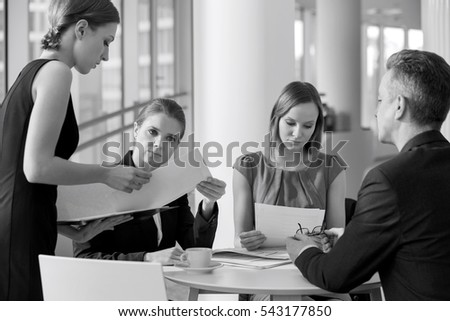 Business people doing paperwork in office cafeteria