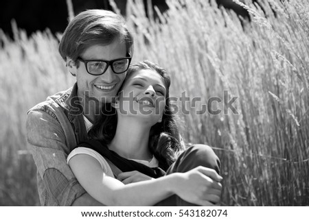Romantic couple relaxing in field