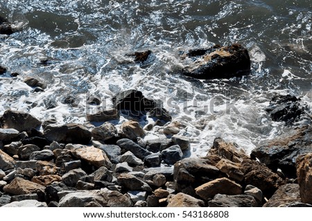 sea, rocks and iridescent reflections