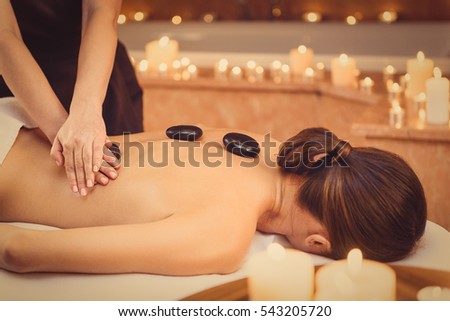 Relaxed girl enjoying body treatment at wellness center Royalty-Free Stock Photo #543205720