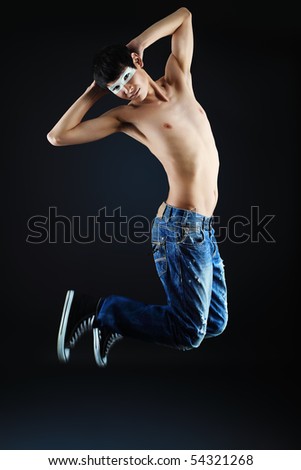 Shot of a jumping over black background young man.