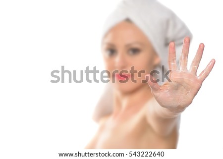 beautiful young woman showing a stop sign with body lotion on her hand. hand in focus. Isolated