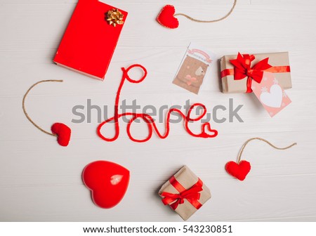 decorations for Valentine's Day. gifts, heart and the words "Love" on white wooden background