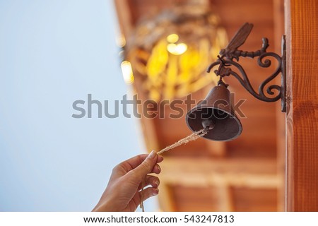 woman rings the Christmas bell