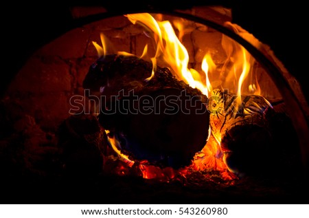 red hot embers in oven in darkness