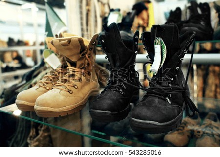 Special army boots on glass shelf at exhibition