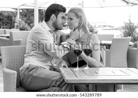 Affectionate young couple spending quality time at outdoor restaurant