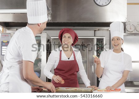 Cooking gourmet pizza in an professional industrial restaurant kitchen