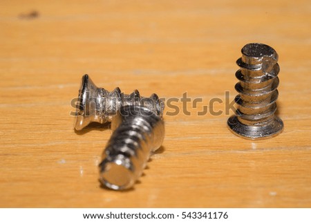 3 screw on wood backgound