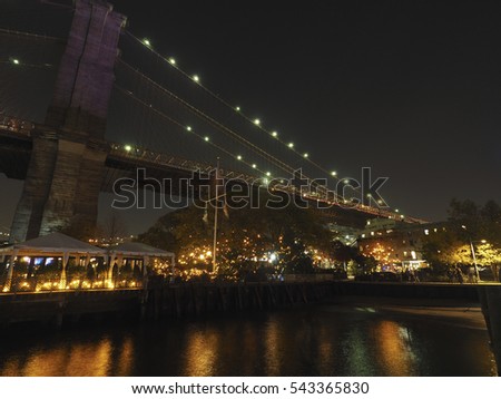 New York City's Brooklyn Bridge and Manhattan skyline illuminated at night 