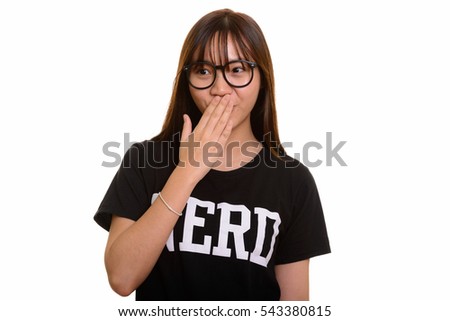Young cute Asian nerd teenage girl looking shocked
