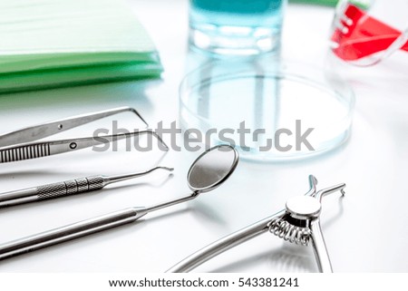 dentists tools in cabinet on white desktop
