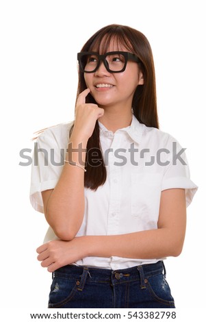 Young happy Asian teenage girl smiling and thinking