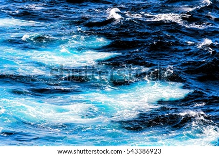 Atlantic ocean with cyan blue water on a sunny day. Waves, foam, wake caused by cruise ship, color effect filtered image for tourism business concept, cruise sailing blogs, magazines websites
