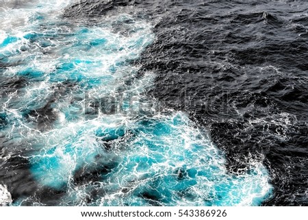 Atlantic ocean with cyan blue water on a sunny day. Waves, foam, wake caused by cruise ship, color effect filtered image for tourism business concept, cruise sailing blogs, magazines websites