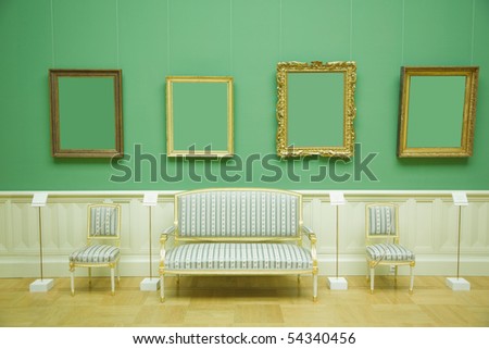 picture frames in green room of museum, stripes chair and sofa with golden wood