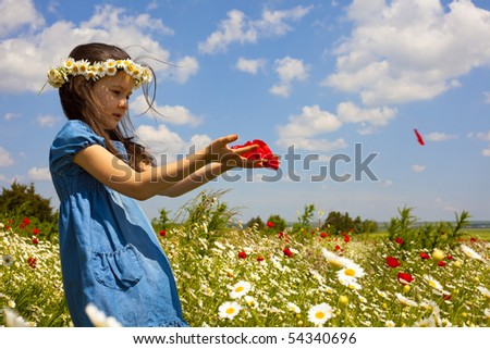 Sweet little girl on the beauty field with wild flowers